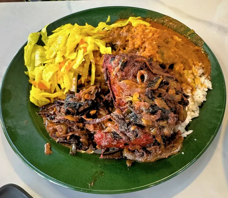 Line Clear nasi kandar up close: onion fried chicken, curried cabbage, and rice flooded with curry
