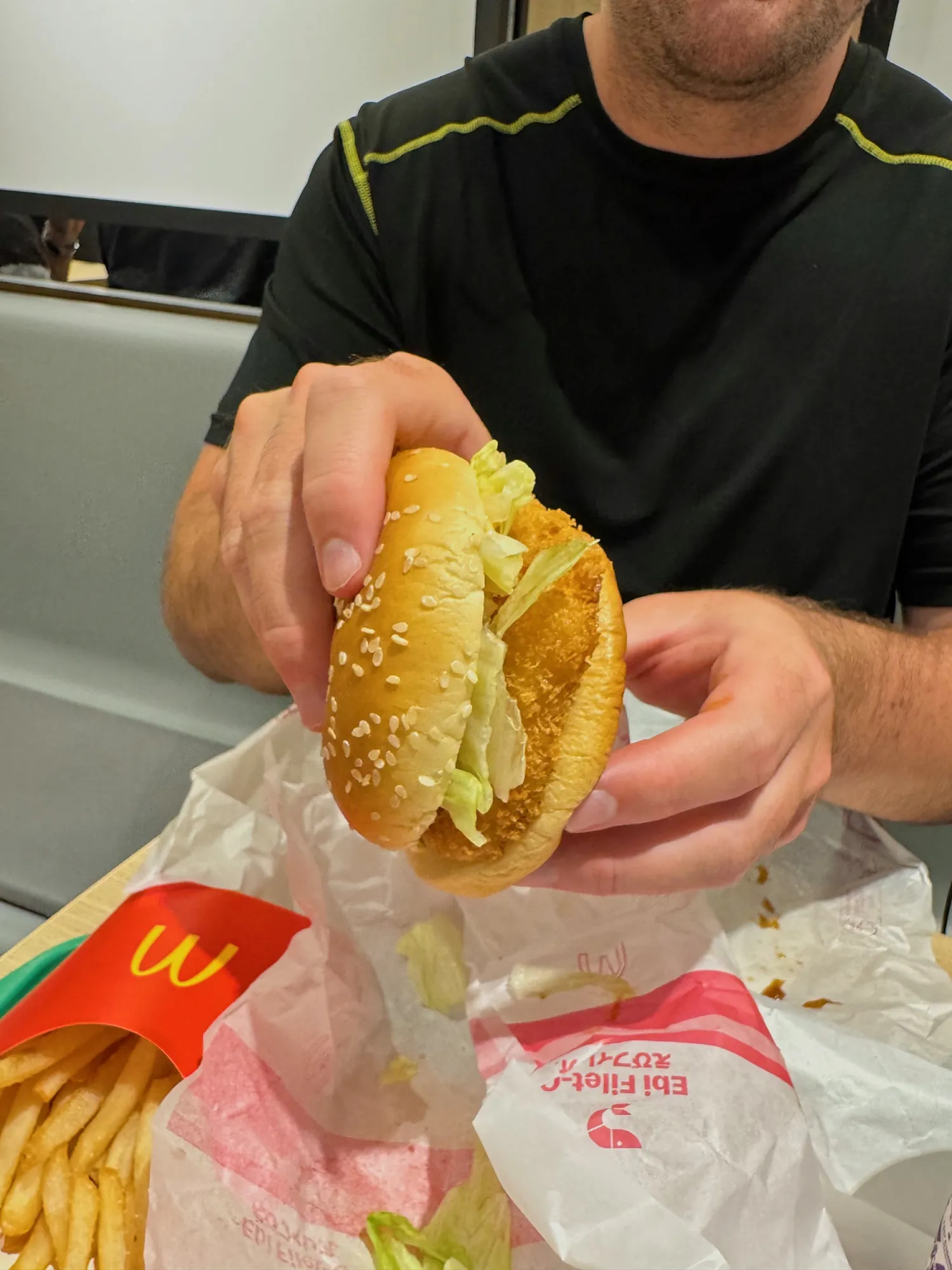 An Ebi Filet-O shrimp burger held up next to fries at McDonald's in Osaka, Japan.