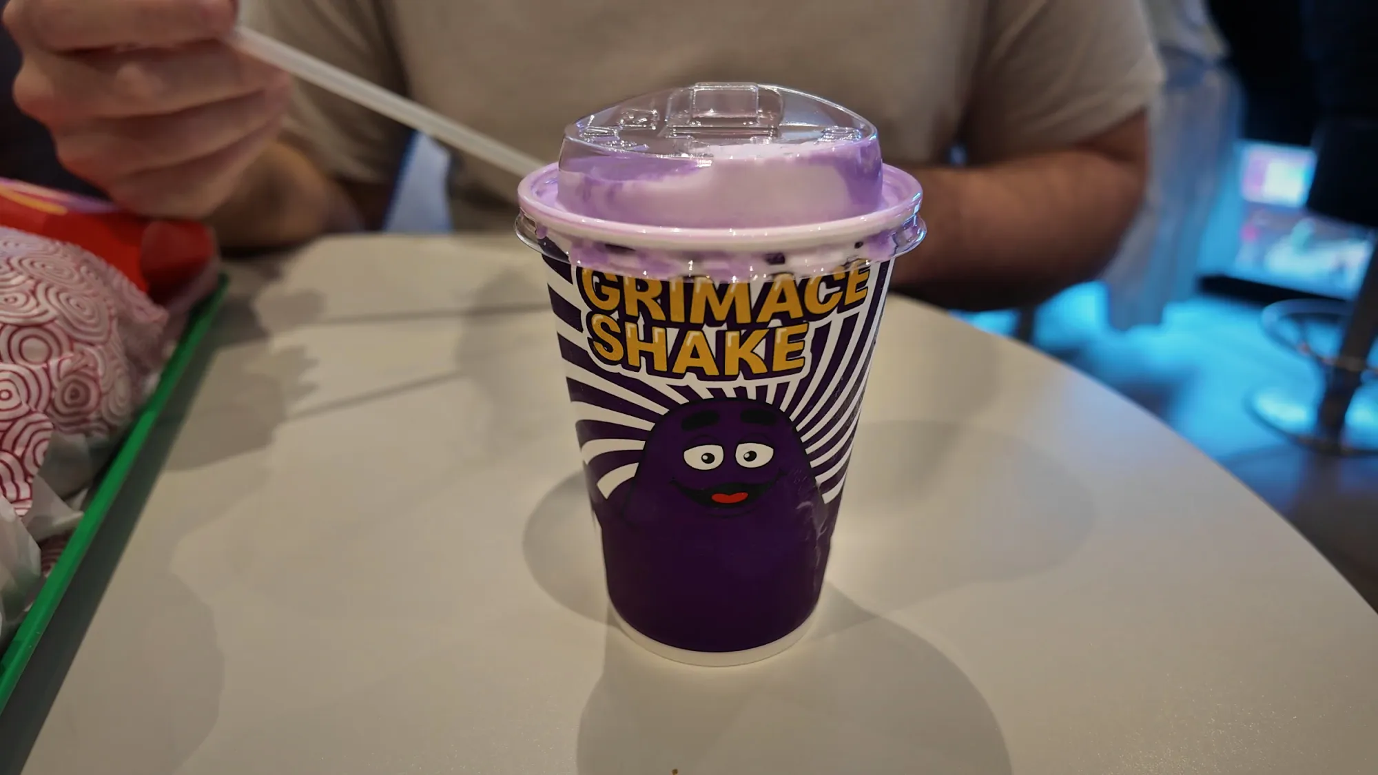 A purple Grimace Shake in a Grimace-printed cup at McDonald's in Japan.
