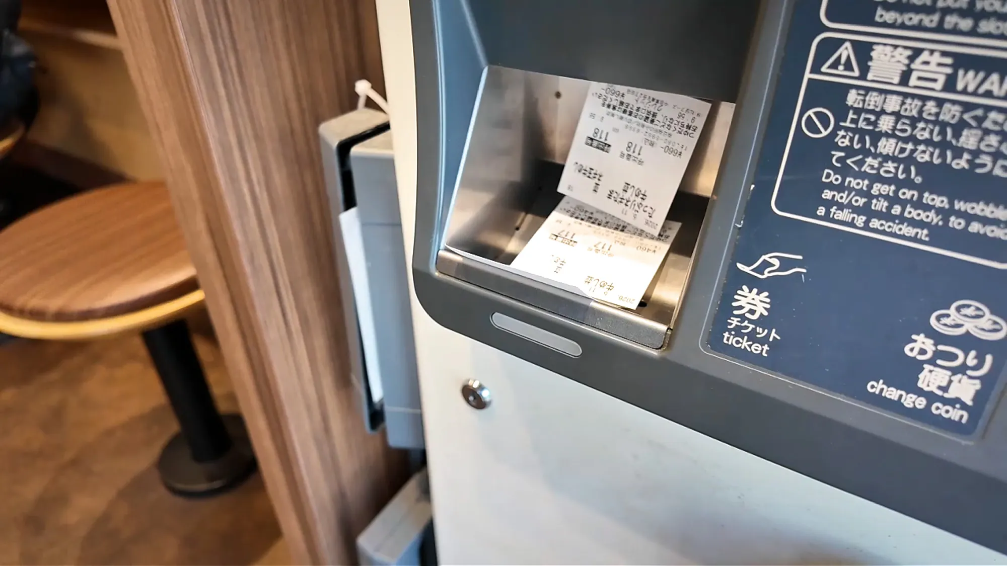 Printed meal tickets in the tray of the Matsuya ordering kiosk in Tokyo.
