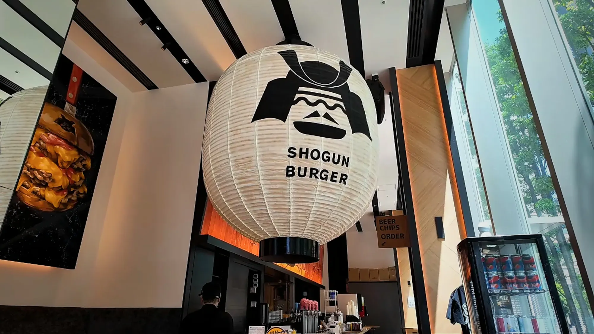 The white paper lantern with the Shogun Burger logo hanging inside the Tokyu Kabukicho Tower branch