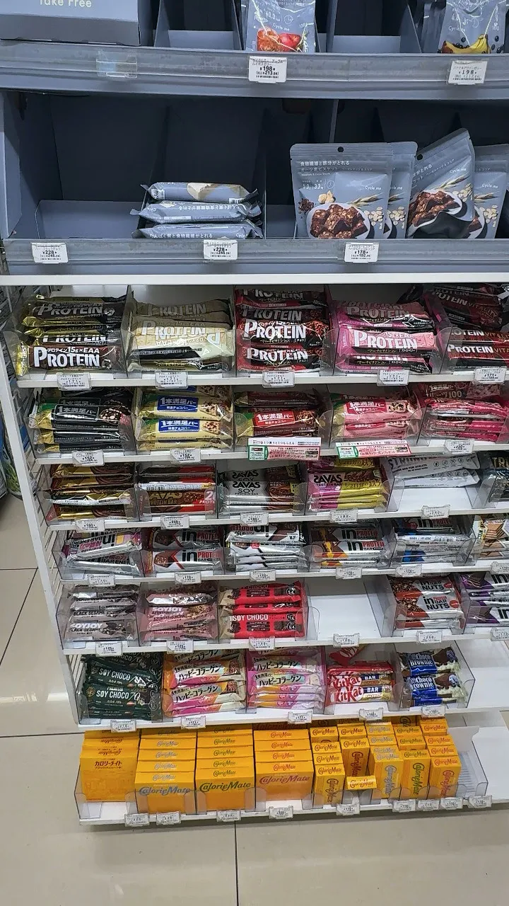 A tall shelf of protein bars in many brands and flavors at a 7-Eleven in Tokyo.