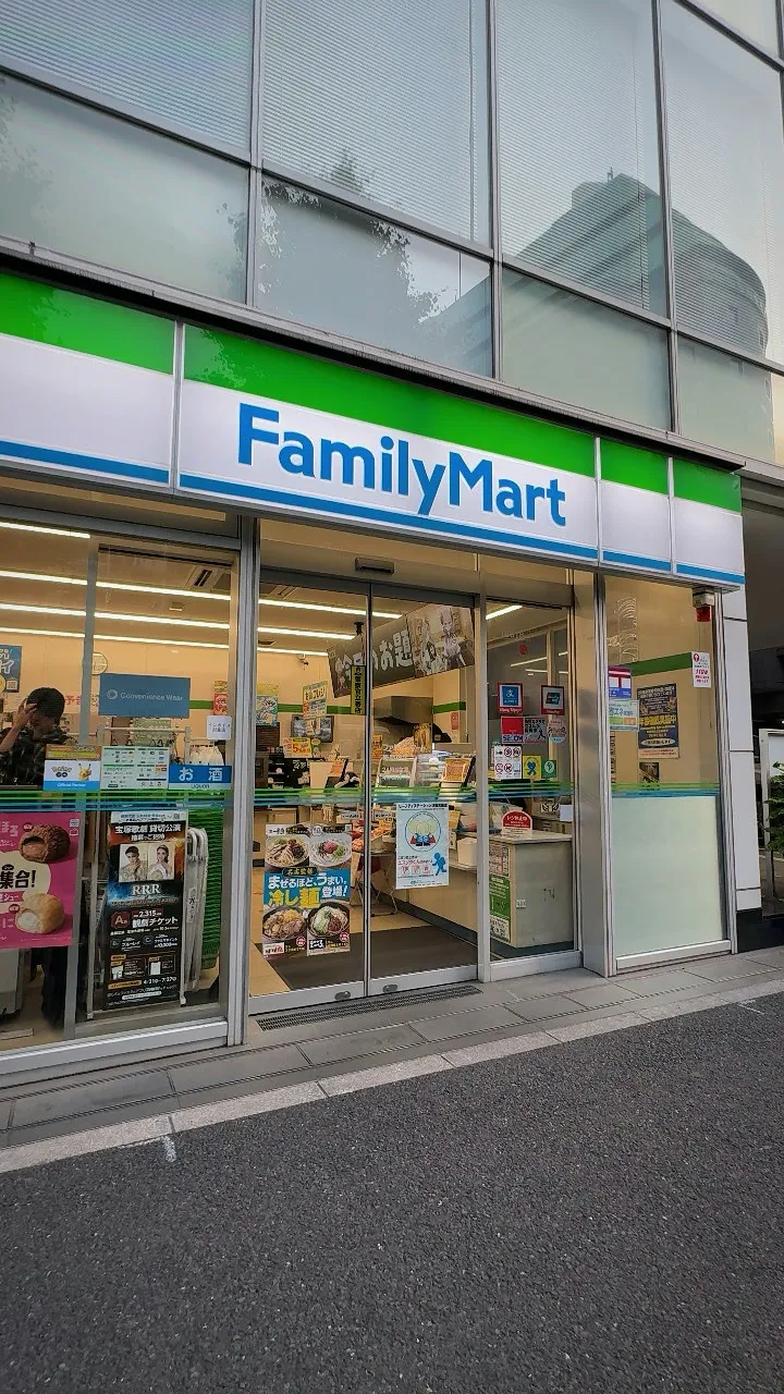 The front of a FamilyMart convenience store in Tokyo with its green, white, and blue sign.