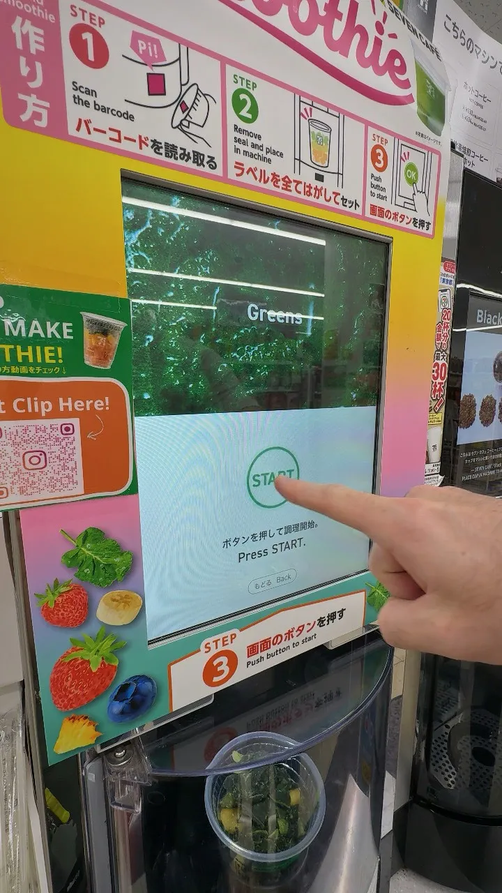 A finger pressing the START button on the 7-Eleven smoothie machine screen, with the numbered Step 1, 2 and 3 instructions above it.