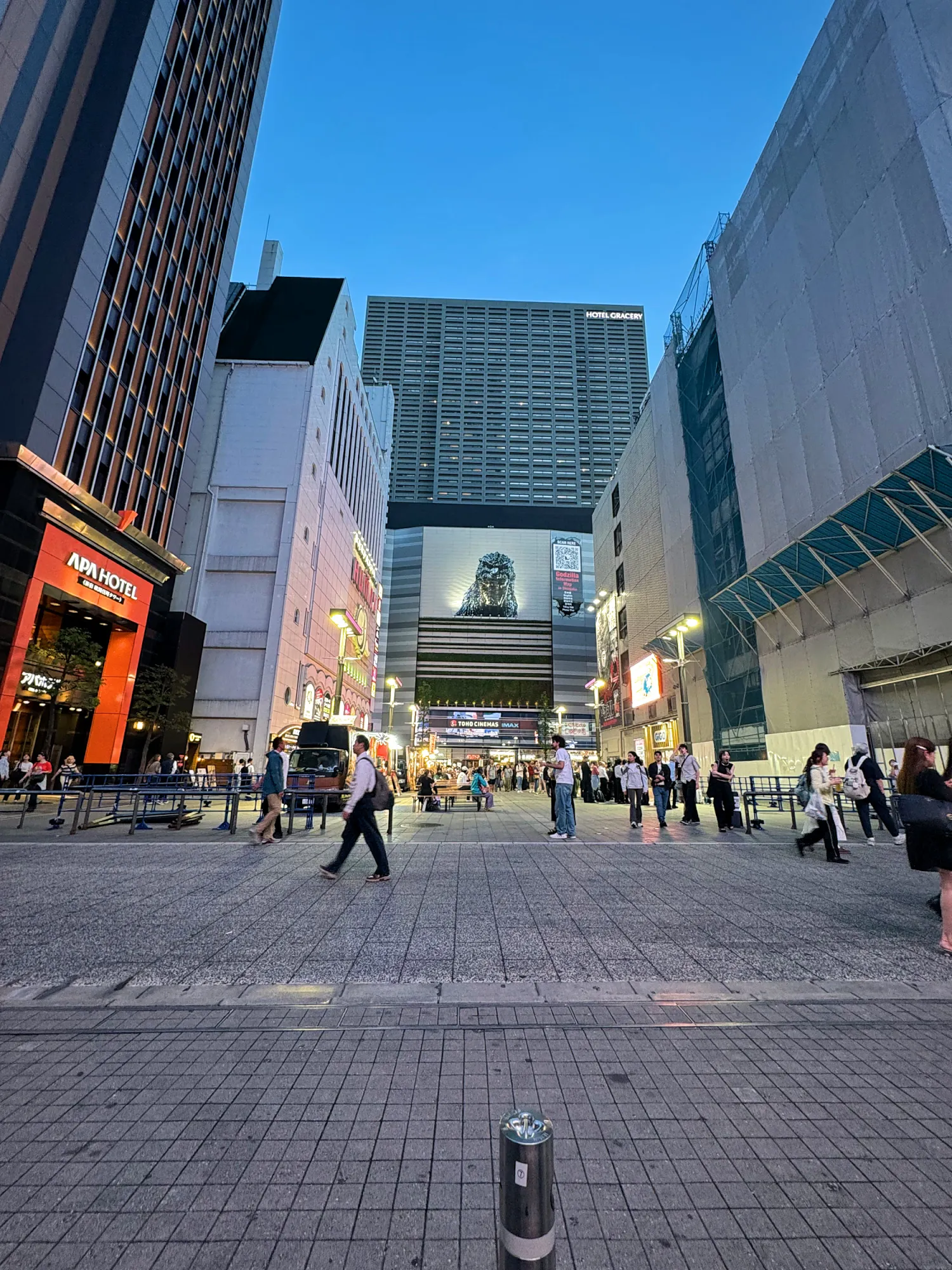 Godzilla Road in Kabukicho, Shinjuku, at dusk, with the Godzilla head on the Shinjuku Toho Building at the end of the street.