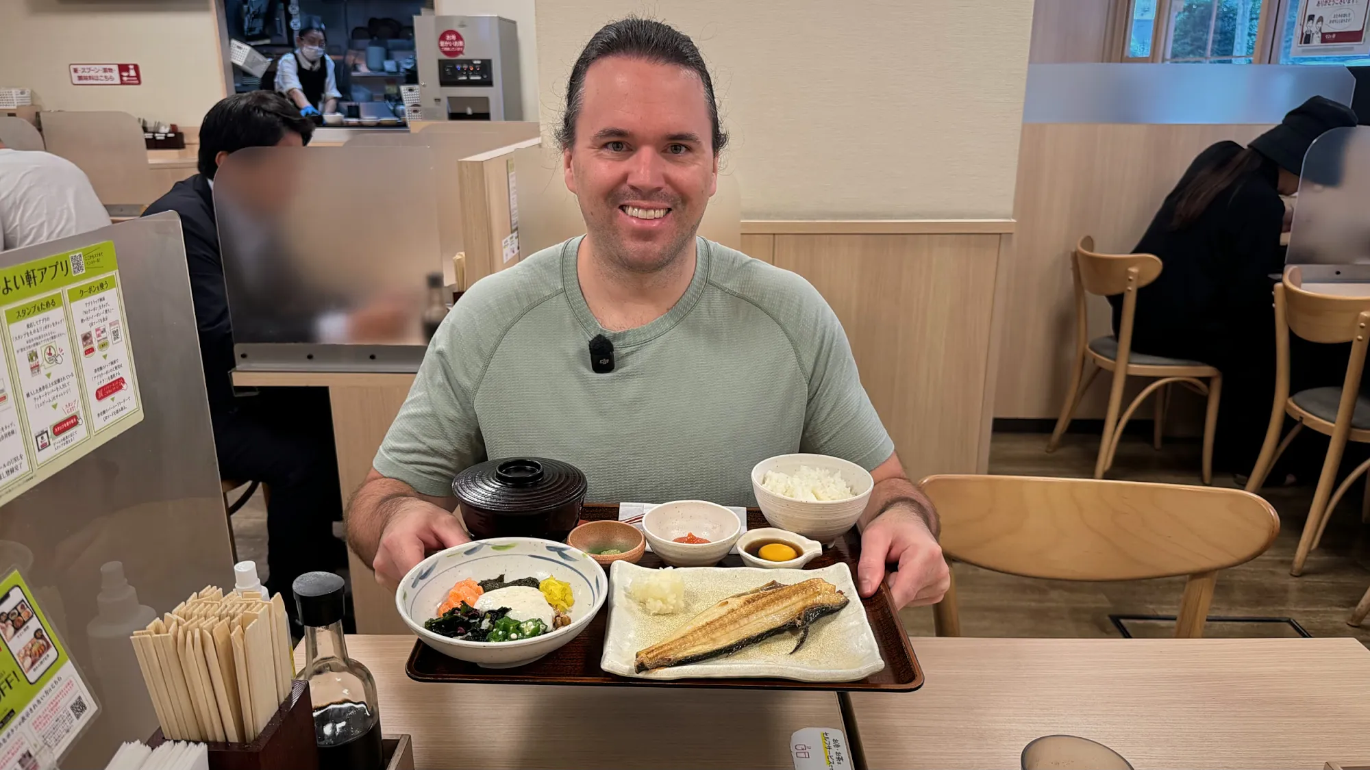Cream smiling at a Yayoiken table behind a Japanese breakfast tray