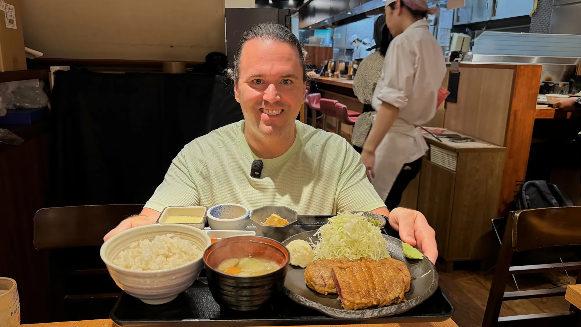 Cream smiling behind a gyukatsu set with barley rice, soup, and cabbage