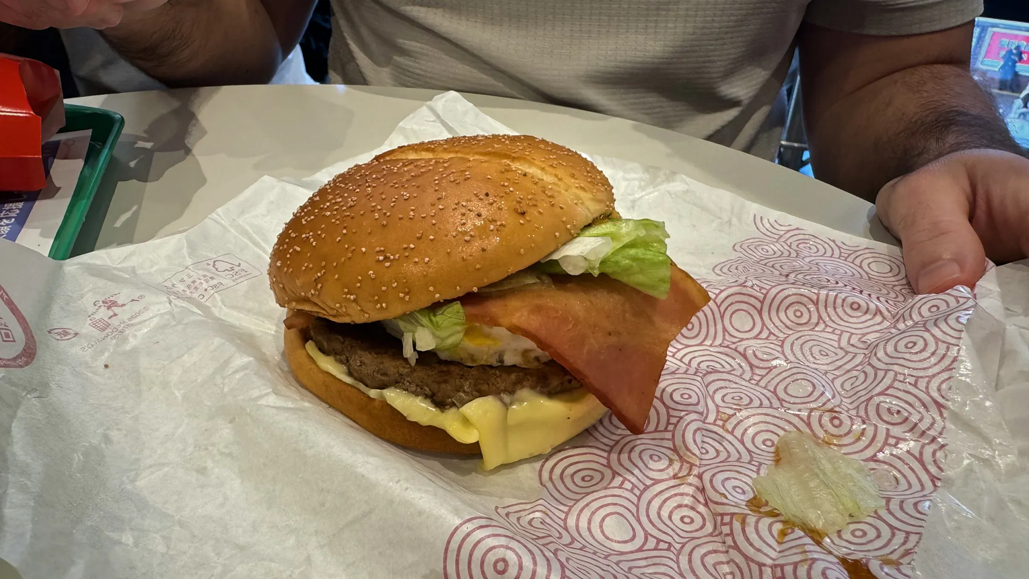 A Samurai Mac burger with bacon and lettuce in a red-patterned wrapper at McDonald's in Japan