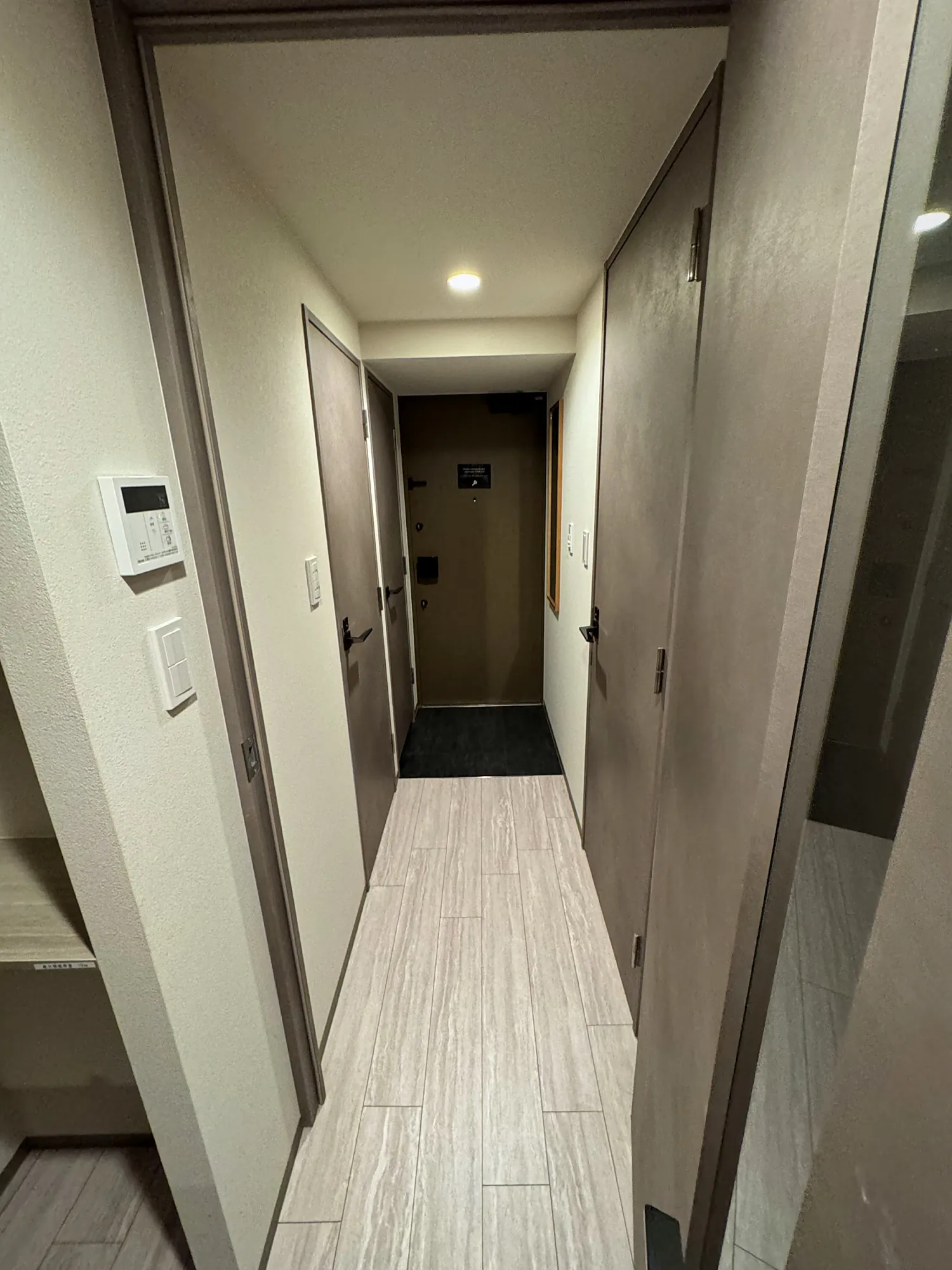 The narrow entry hall of our Tokyo apartment, with a tiled step at the front door where shoes come off.