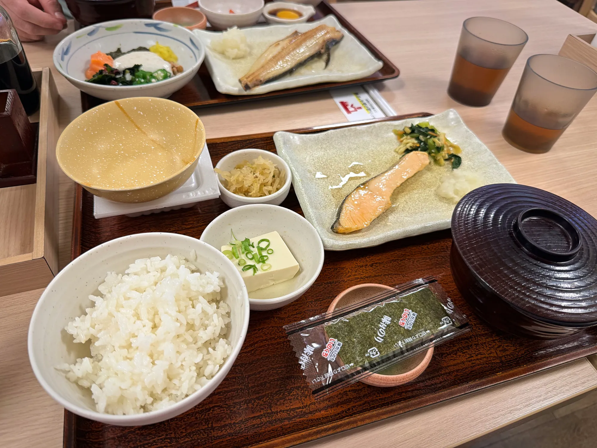 A Yayoiken breakfast tray with grilled salmon, a big bowl of rice, miso soup, tofu, and pickles