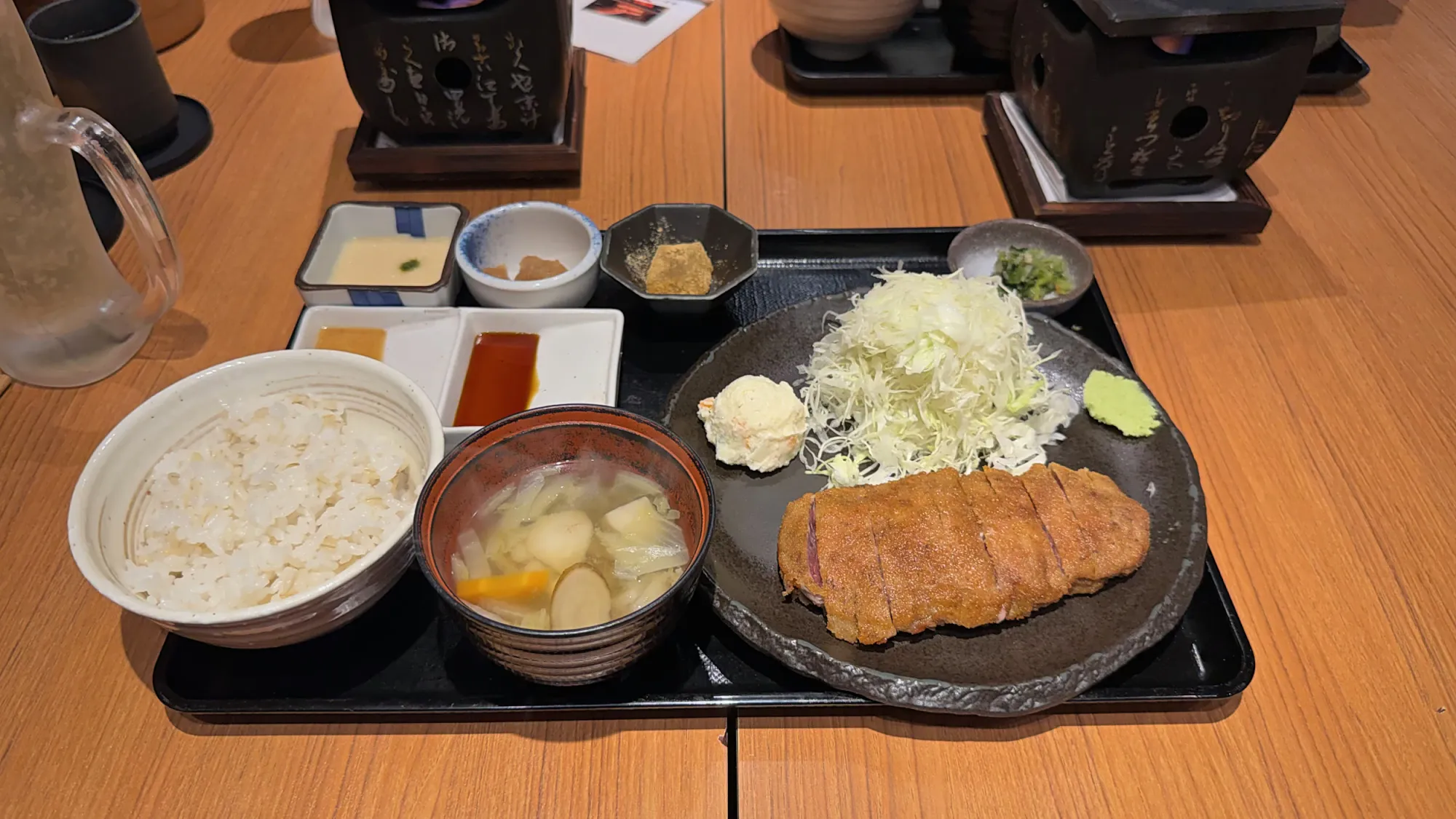 A gyukatsu set with beef cutlet, shredded cabbage, rice, and soup on a tray at Gyukatsu Motomura in Tokyo.