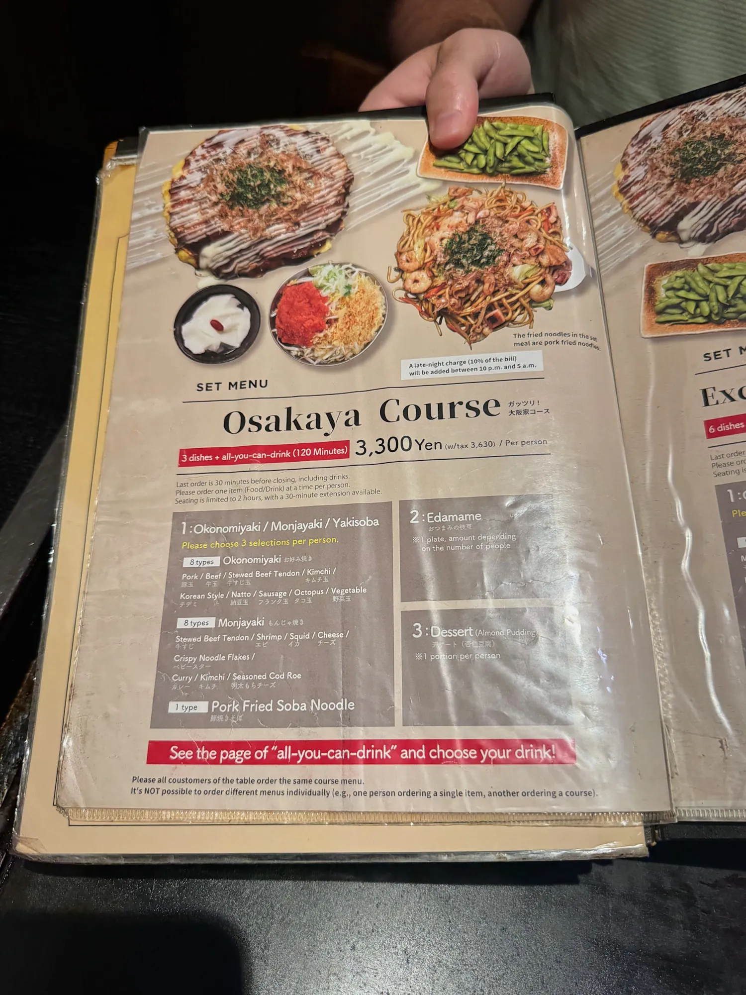 The English menu page for the Osakaya Course at Osakaya in Shinjuku, showing okonomiyaki, monjayaki, yakisoba, edamame, and the all-you-can-drink price.