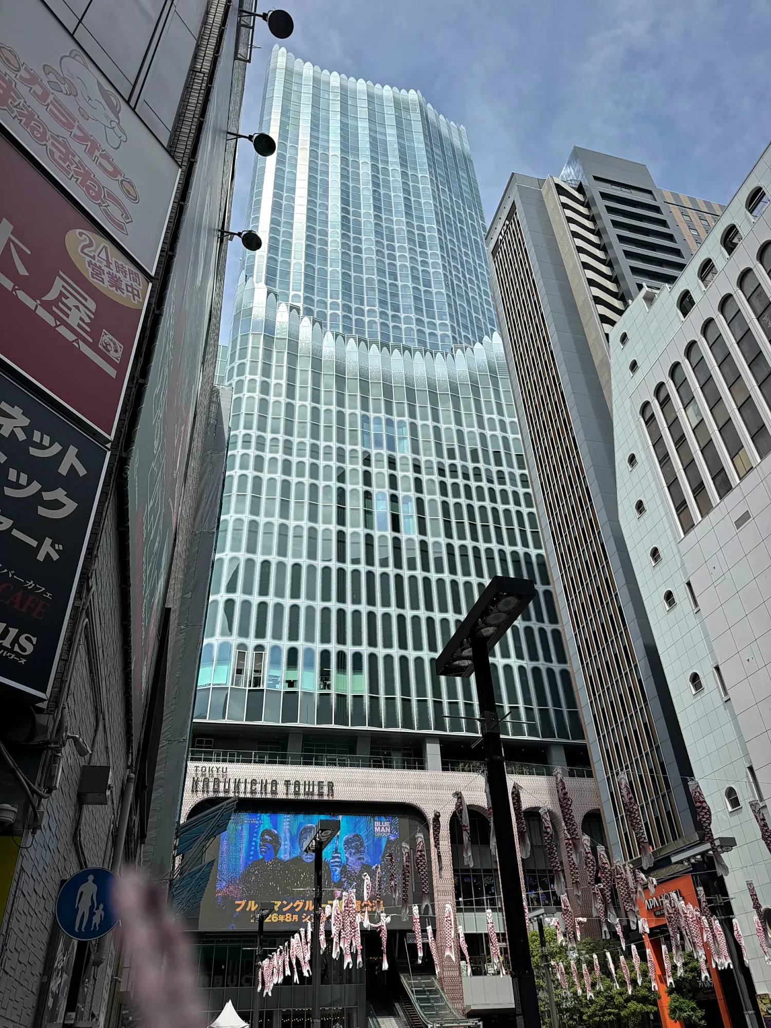 The glass Tokyu Kabukicho Tower rising above a street in Kabukicho, Shinjuku, home to the quieter Shogun Burger branch on its ground floor.