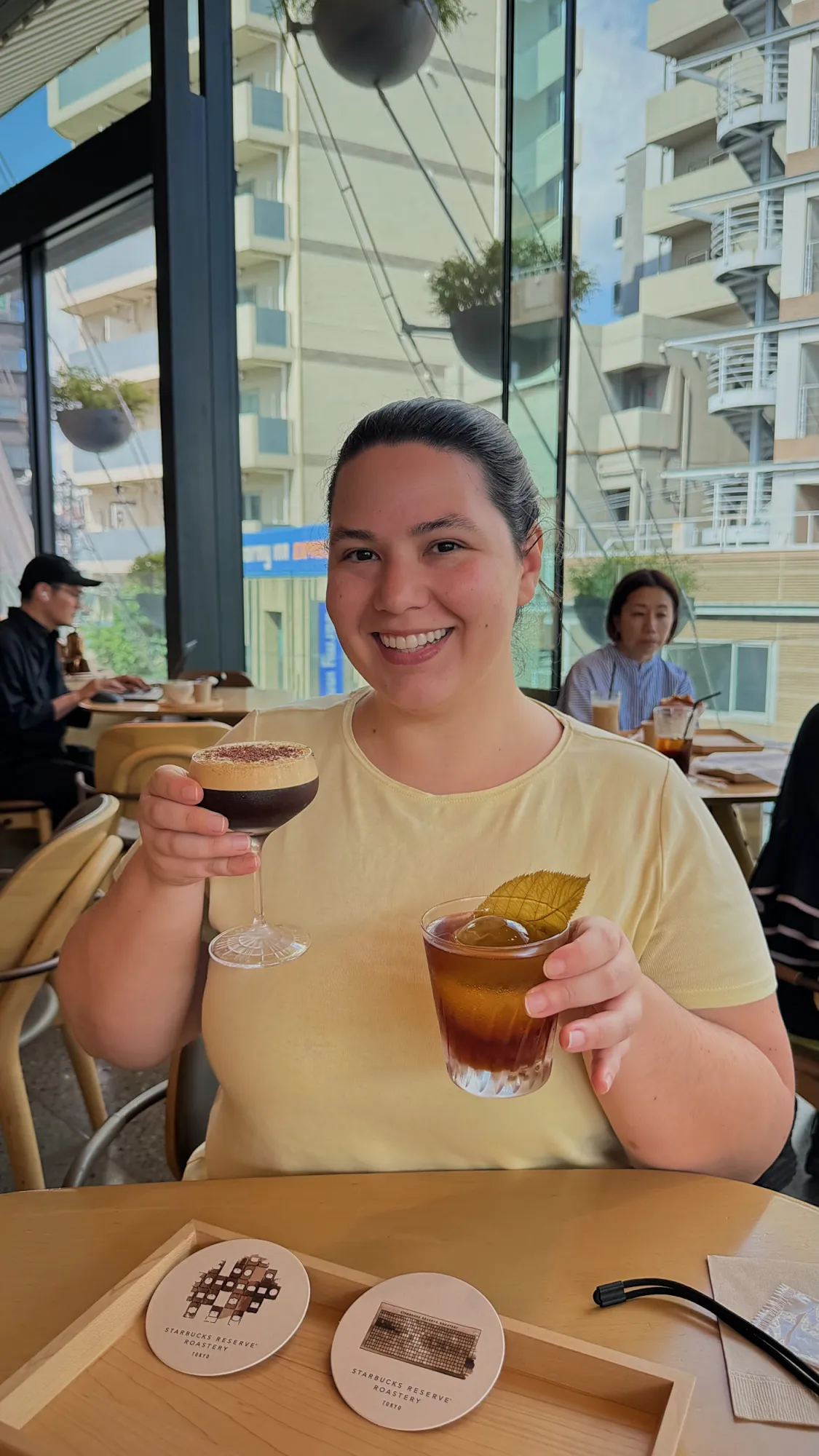 Bernie smiling and holding up two coffee cocktails at the Starbucks Reserve Roastery Tokyo