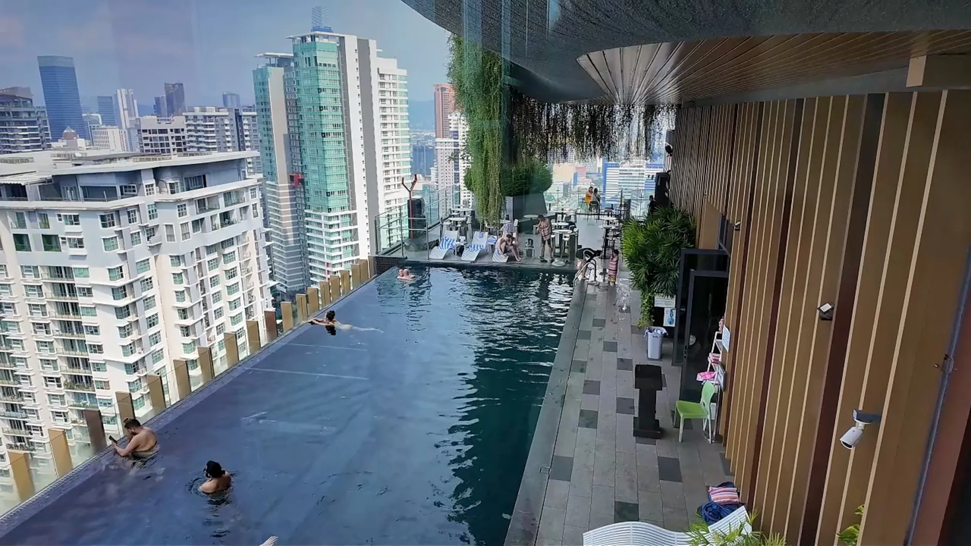 The KL Tower reflected in the rooftop infinity pool at Ceylonz Suites in Kuala Lumpur.