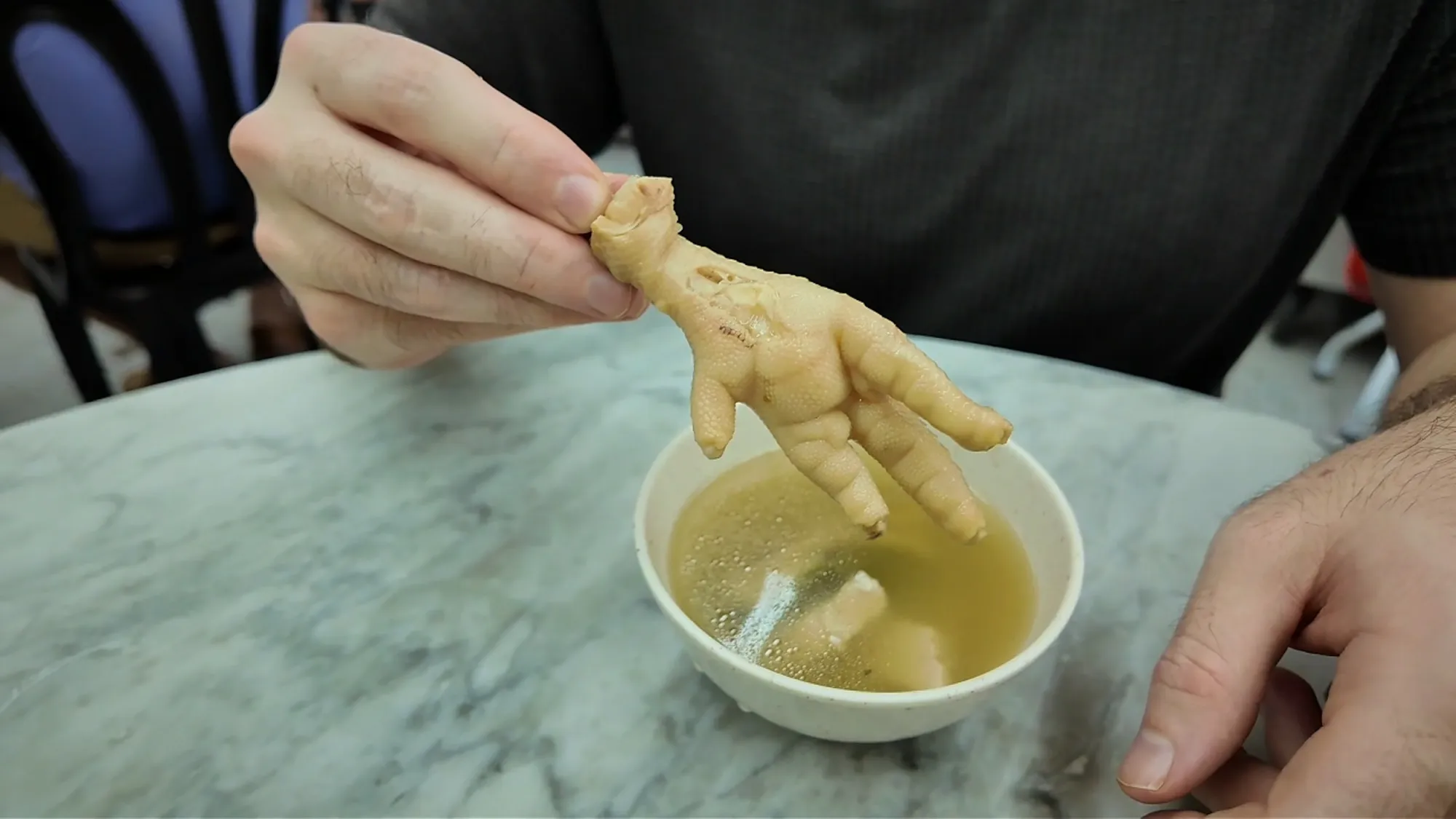 Chicken food over bowl of soup
