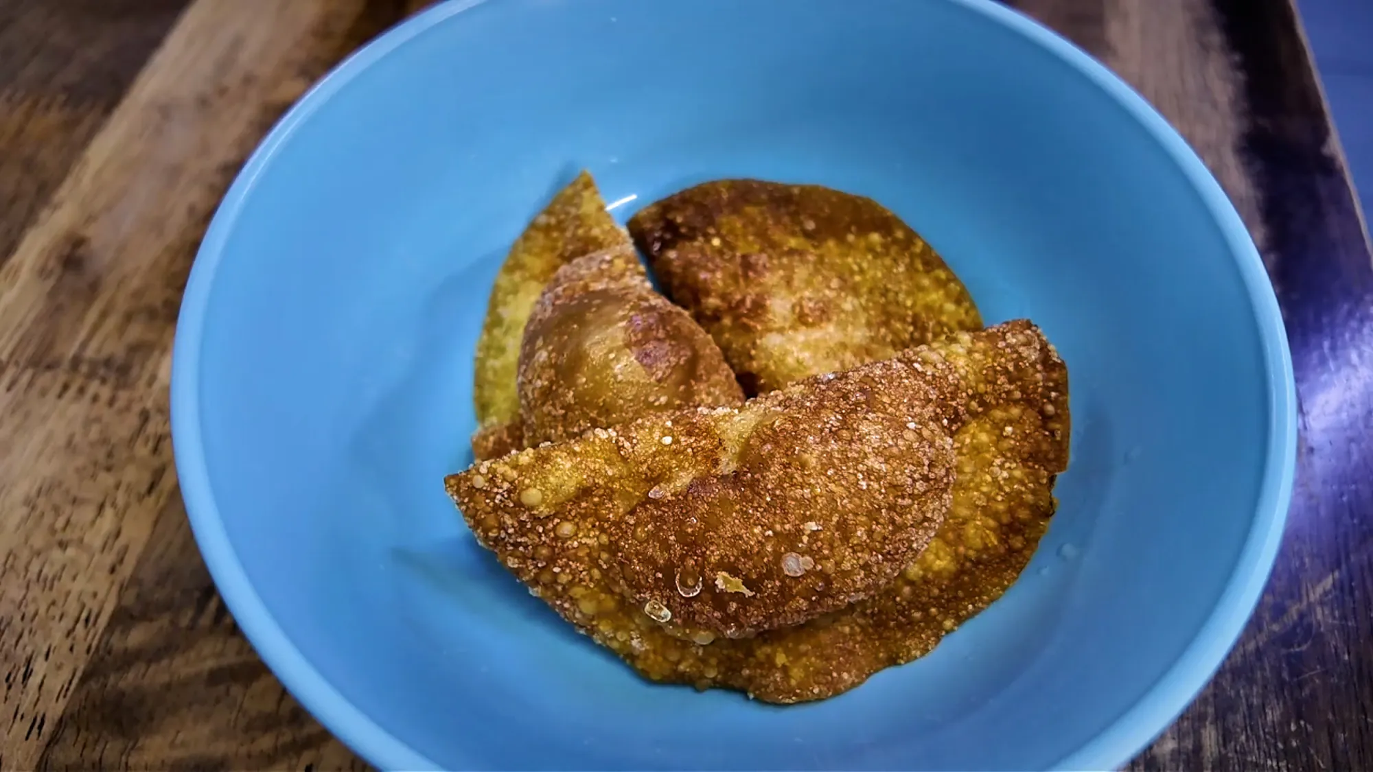 Crispy golden fried dumplings in a blue bowl at Kin Kin chili pan mee, Kuala Lumpur.