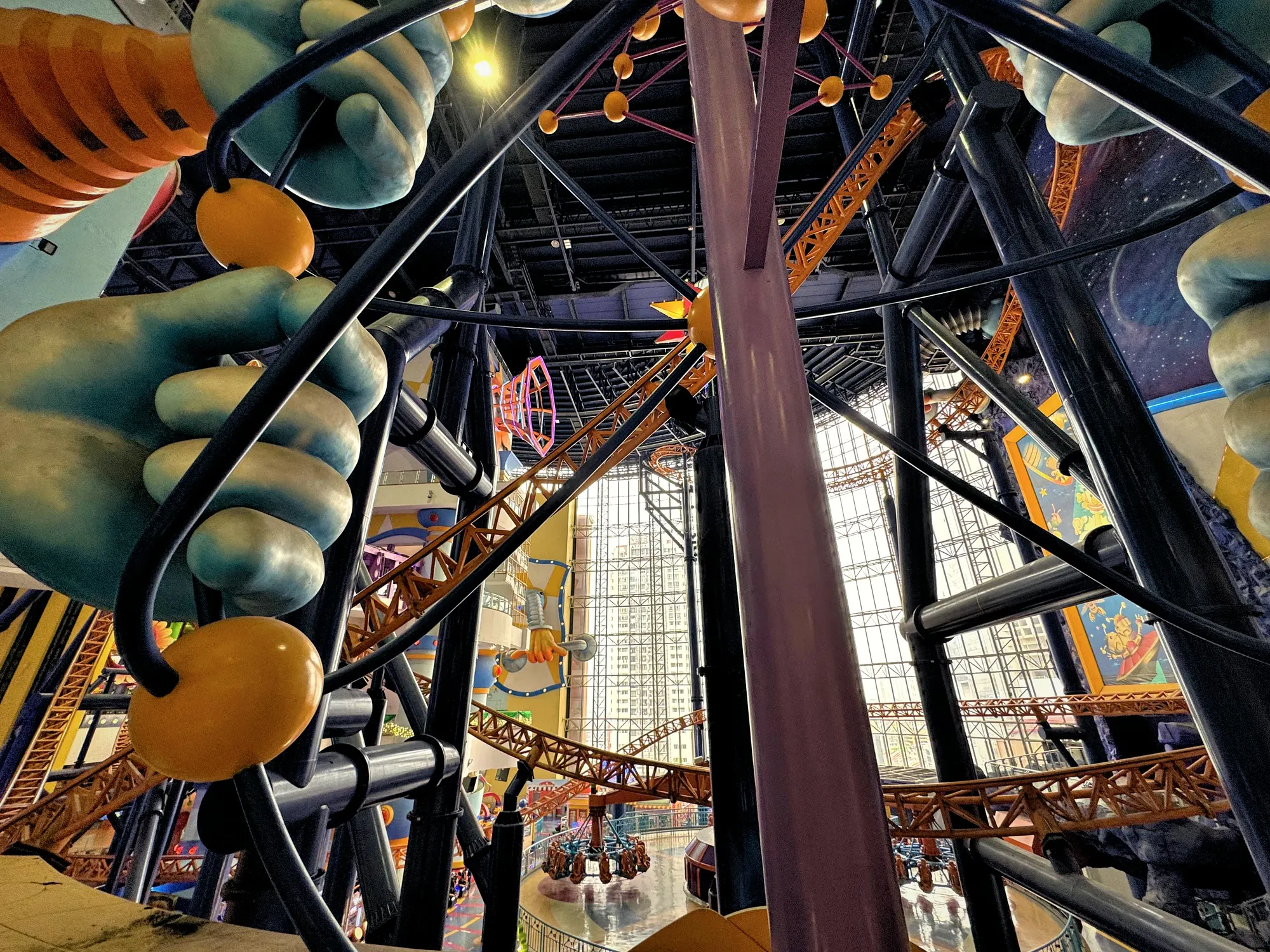 Looking up at the steel supports and loops of the indoor roller coaster at Berjaya Times Square.