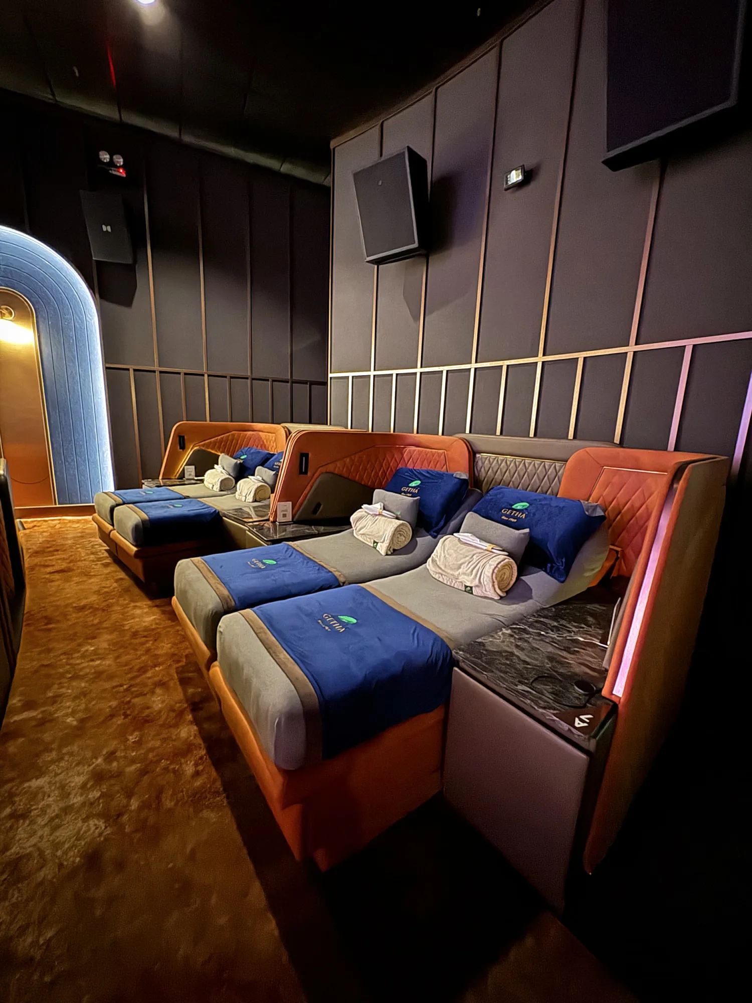 Bed-style recliners with blue blankets and pillows in a Getha Lux Suite at Aurum Theatre, Kuala Lumpur.