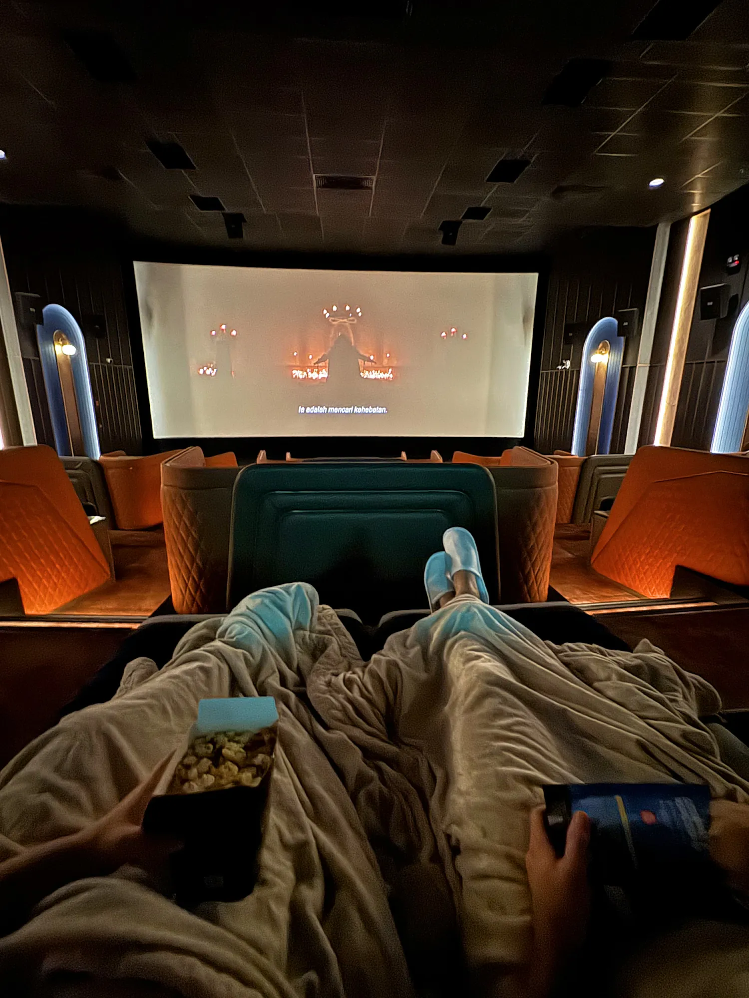 Watching a movie with our feet up under blankets in a Getha Lux Suite at Aurum Theatre, Kuala Lumpur.