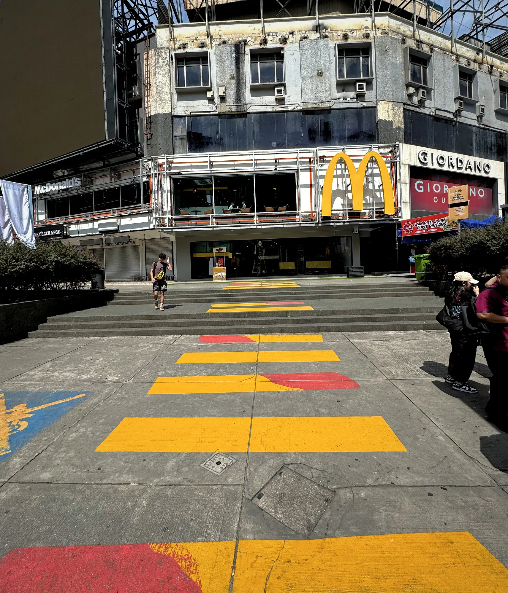 The famous painted McDonald's french fry crosswalk stretches across the road toward the McDonald's outlet in Bukit Bintang, Kuala Lumpur.