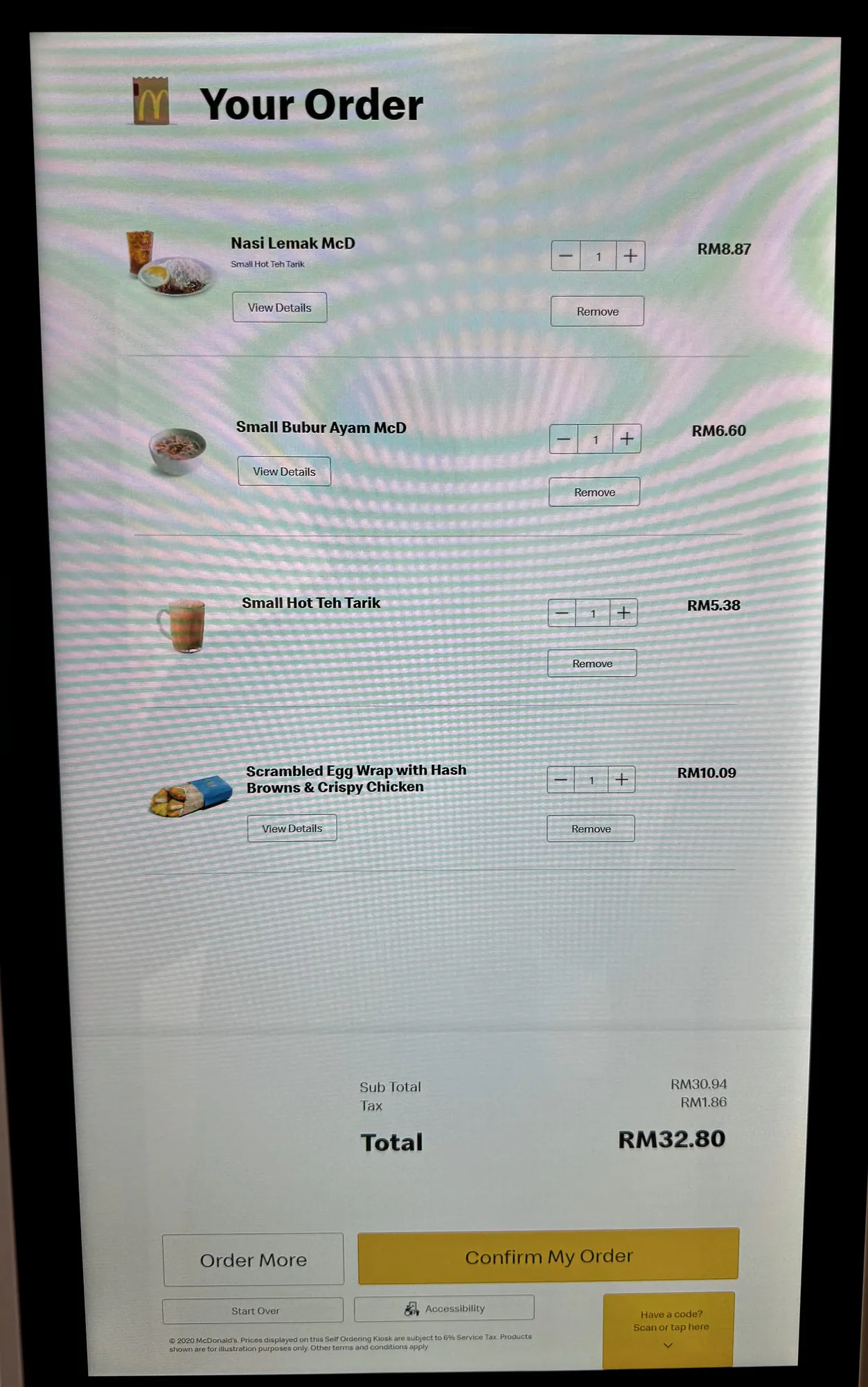 A McDonald's kiosk screen in Bukit Bintang, Kuala Lumpur, showing a breakfast order in English with prices in ringgit.