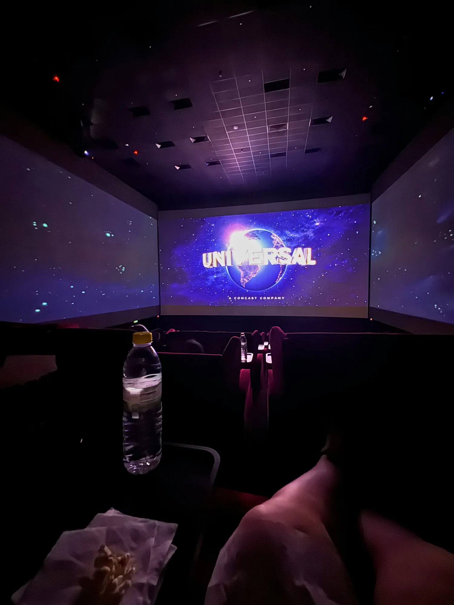 The Universal logo stretching across the front and side walls of the ScreenX hall at Aurum Theatre, Kuala Lumpur.