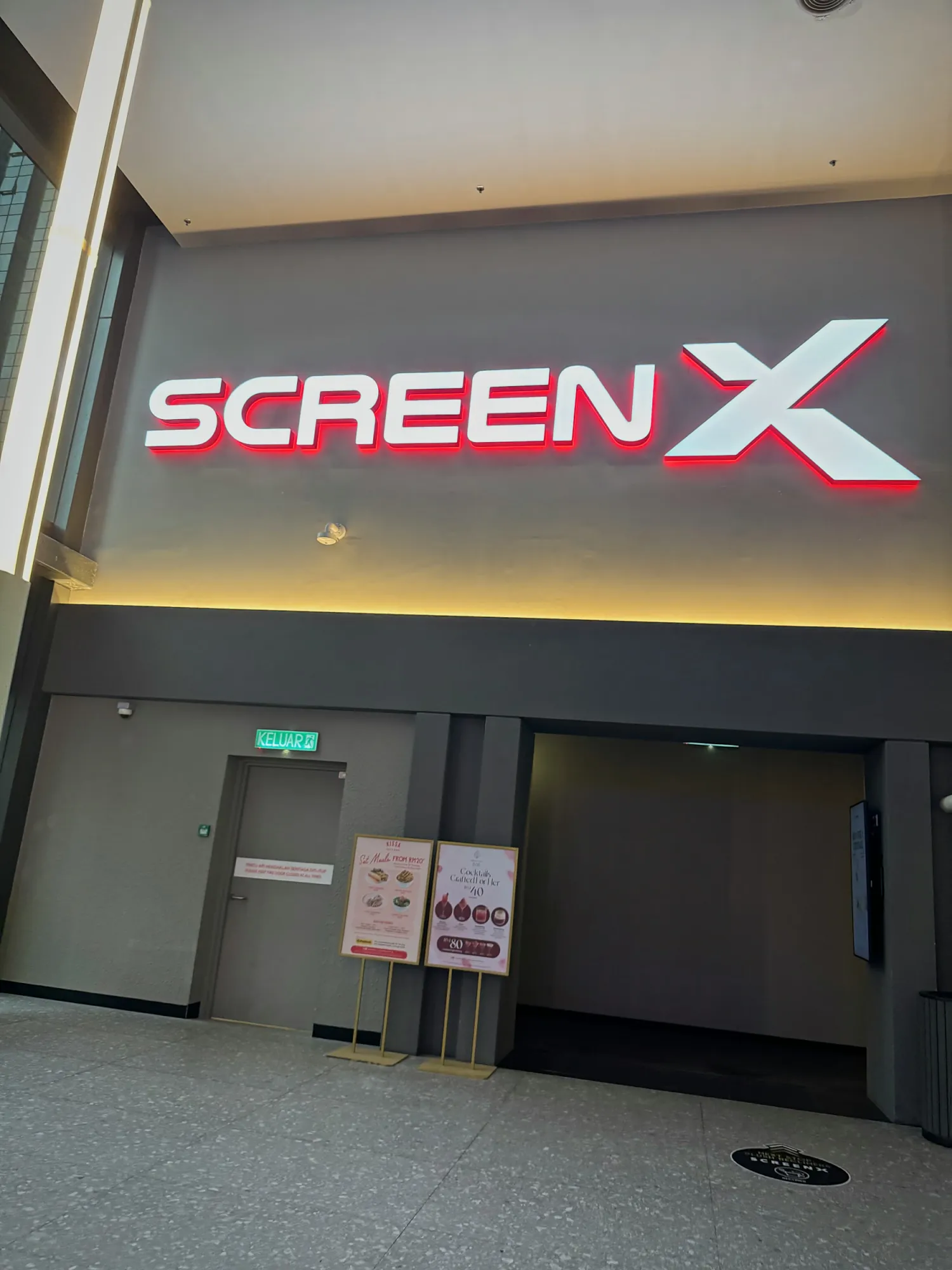The red ScreenX sign above the hall entrance at Aurum Theatre, The Exchange TRX, Kuala Lumpur.